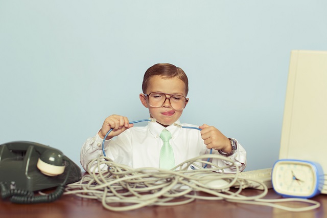 Little boy at home with dangerous wires